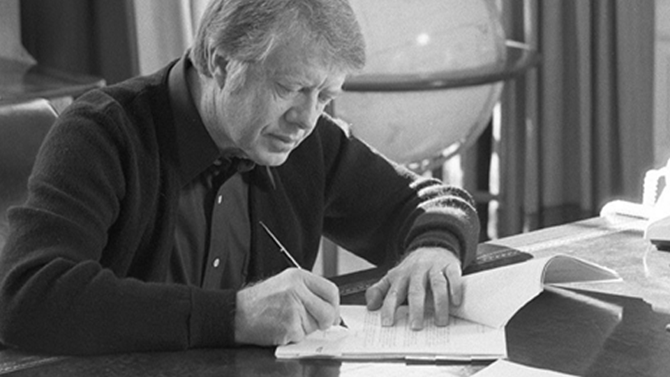 Photo of President Jimmy Carter signing memorandum